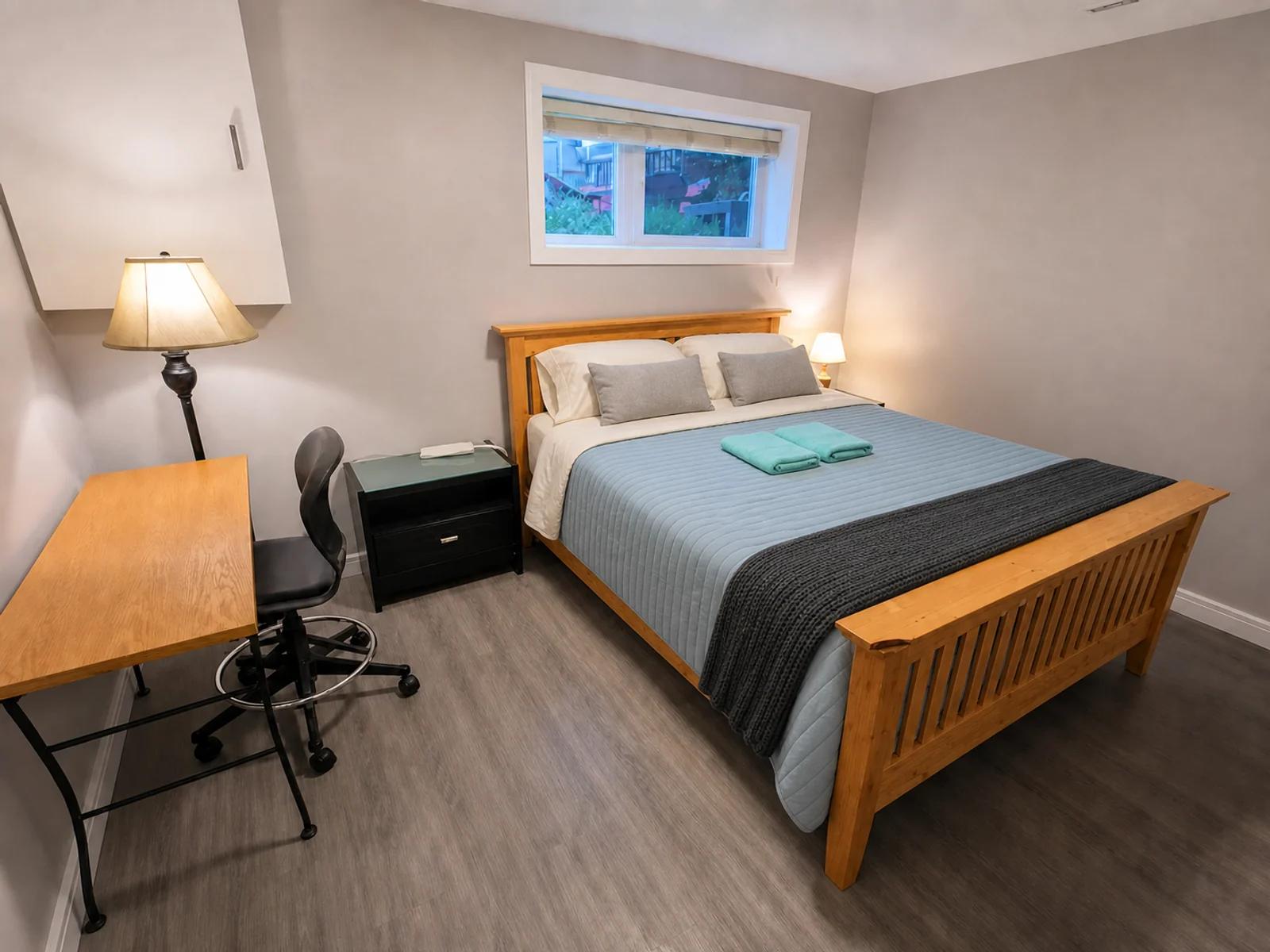 AI-enhanced photo of the bedroom and workspace in the Beddington lower suite