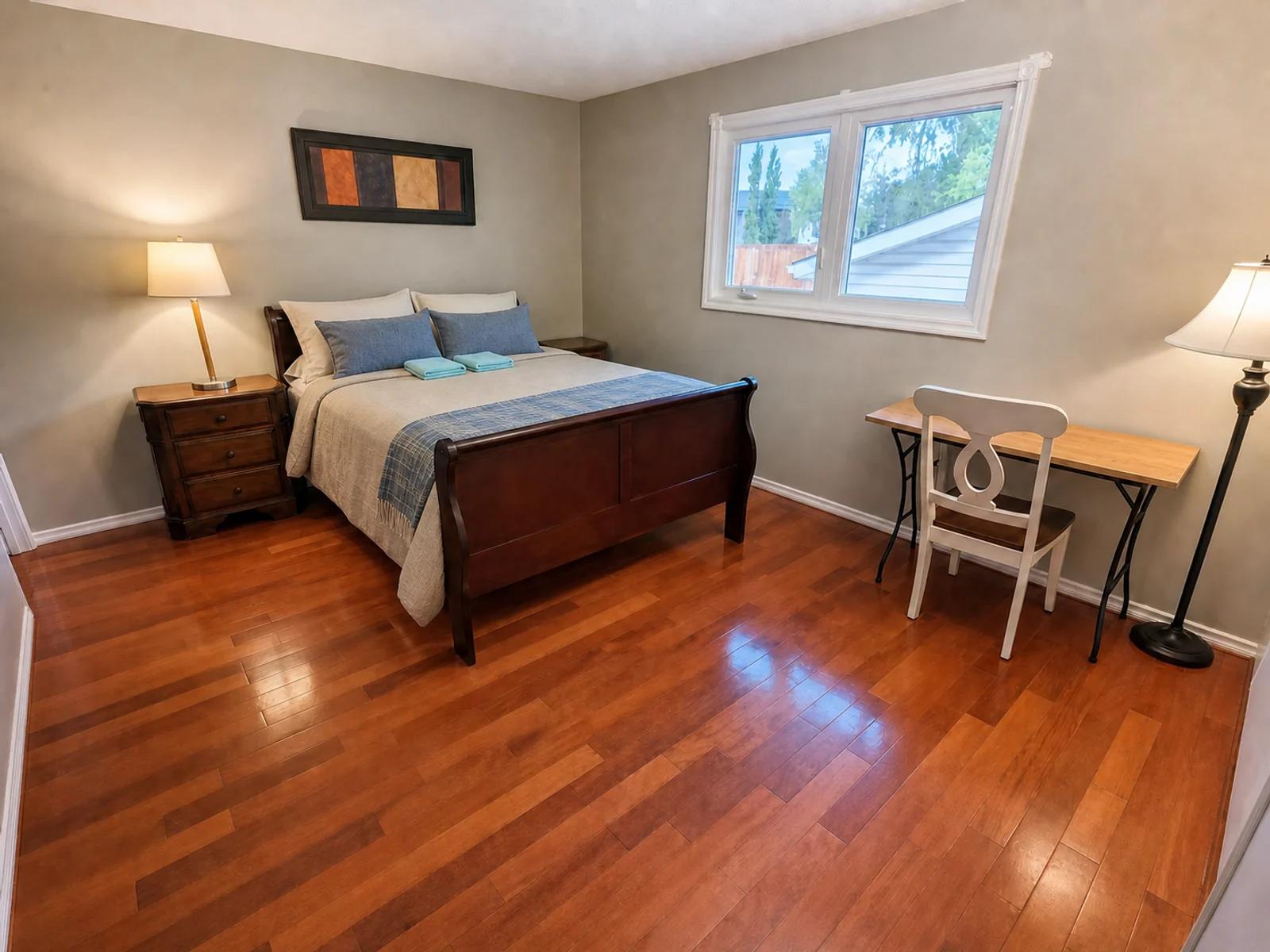 AI-enhanced photo of a bedroom and workspace in the Beddington three-bedroom home