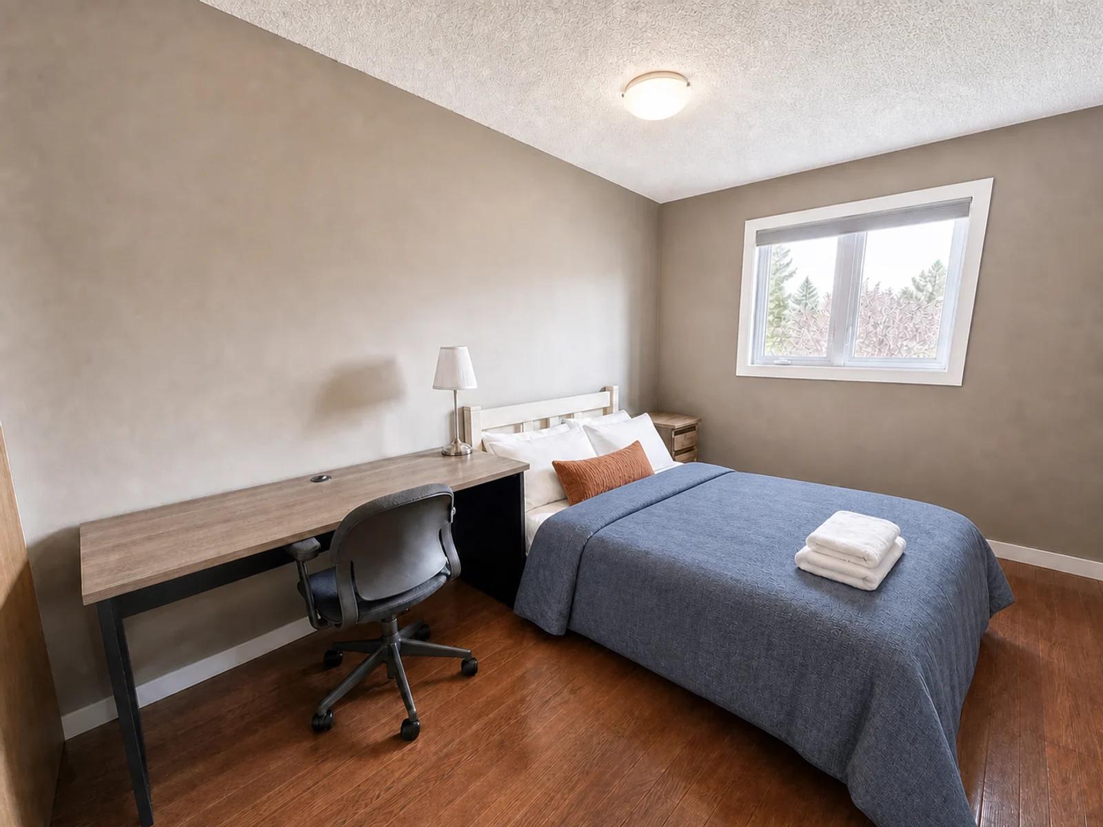 AI-enhanced photo of the queen bedroom and workspace in the Sandstone four-bedroom home